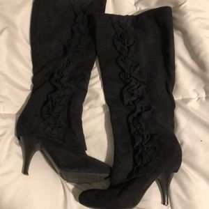 Black boots with ruffles on outside